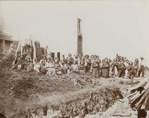 Mixed group kneeling for picture, praying, with two non-Indian priests at right