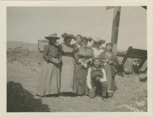 Five women, two men posing "participants in potlatch"