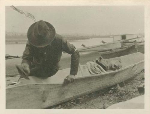 Clayoquot Indian making canoe