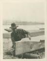 Clayoquot Indian making canoe