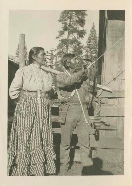 Sampson Grant holding bow and arrow with wife Mary Grant, Burney