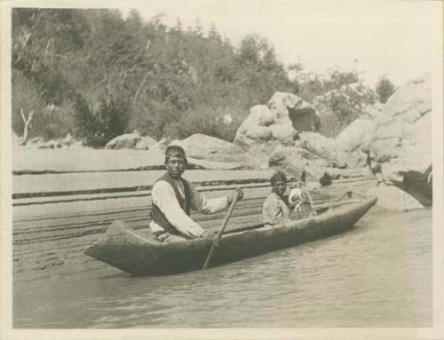 Johnny Joe with his wife and baby in a canoe