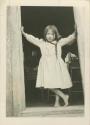 A young girl, Genevieve Brooks, posing for a photo in doorway