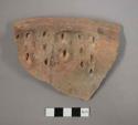 Ceramic rim sherd with impressed design