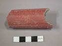 Fragment of red pottery tube-handle?, spout