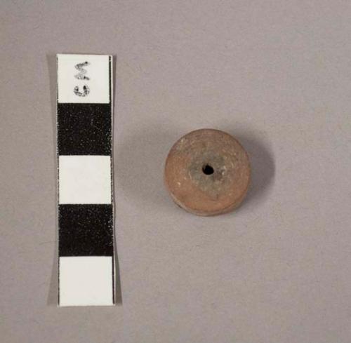 Small plain pottery spindle whorl