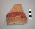 Four red on tan pot sherds with incising on the red part
