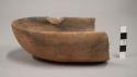 End section of small oval pottery bowl, flat base, undecorated, smoked inside