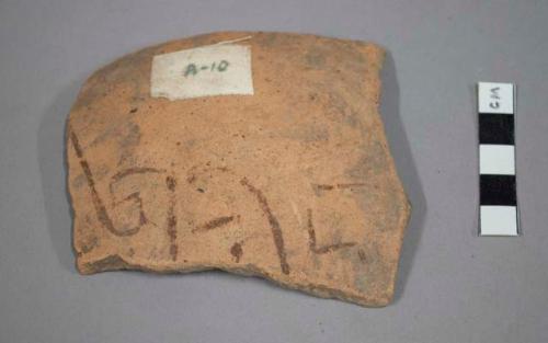 Rim potsherd - shallow bowl, clack decoration on under side