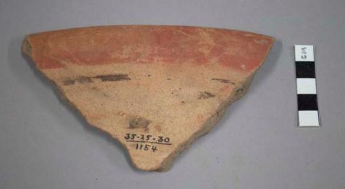 Rim potsherd - red band and black decoration on under side