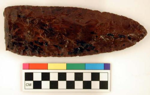 Chipped implement; chipped from red and black mottled obsidian