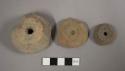 Pottery spindle whorls with molded decoration on top only