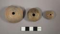 Incised pottery spindle whorls
