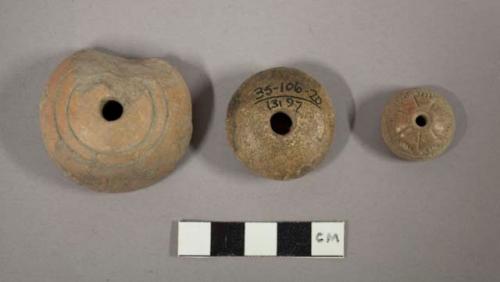 Incised pottery spindle whorls