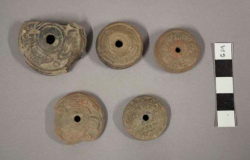 Pottery spindle whorls- molded decoration