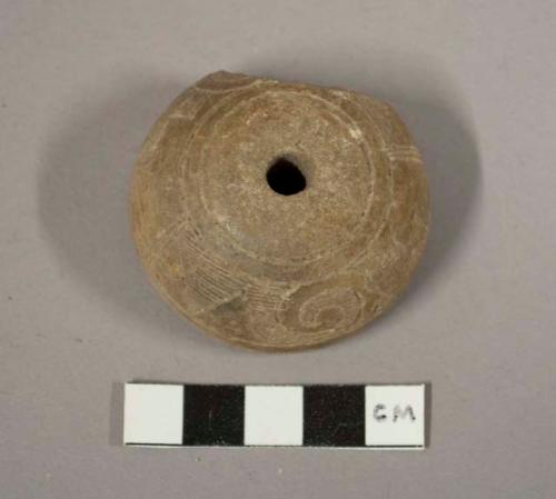 Incised pottery spindle whorl.