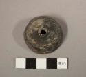 Black pottery spindle whorl-some carved lines on bottom