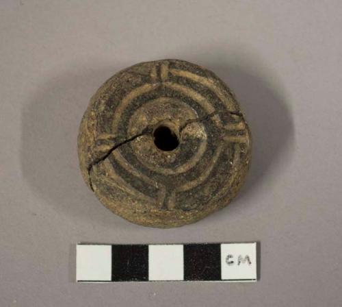 Large stone spindle whorl with design on one side