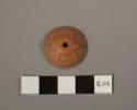 Molded pottery spindle whorl with frog-like animal in relief