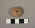 Carved tan pottery spindle whorl