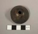 Black ceramic spindle whorl with carved designs