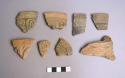 Ceramic body and rim sherds with carved exterior designs