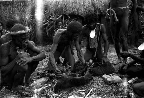 Wali, Milika, Pumika (back) and others cooking a pig for the feast given by Wali and Wereklowé