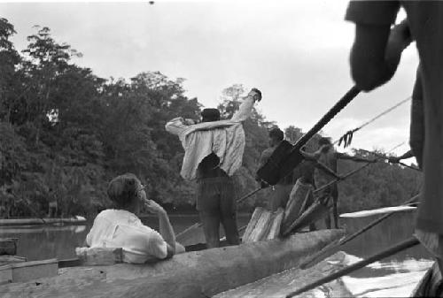 Gerbrands in a canoe with Wastam and 3 other men who are paddling