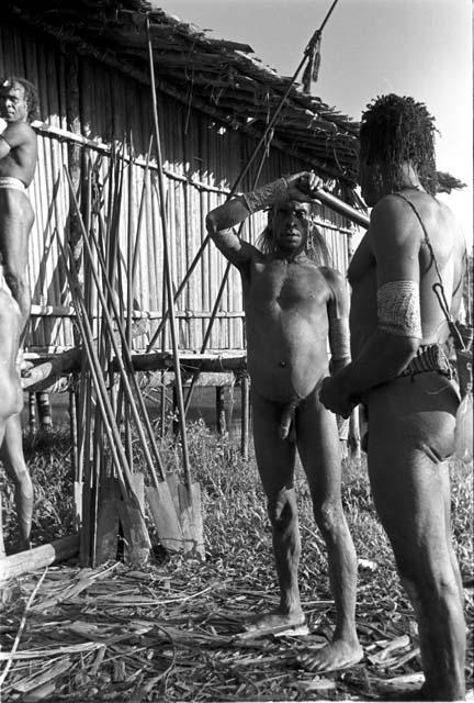 Natives and paddles outside the government resthouse