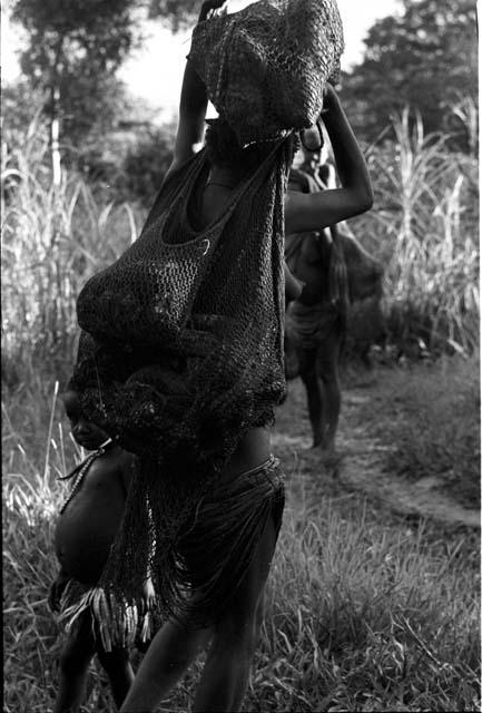 Woman loaded with hiperi on her way home