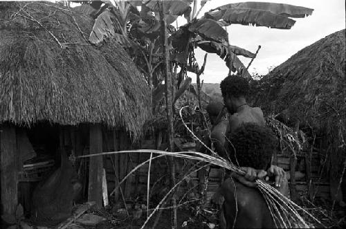 Uwar watches in foreground as Yoli and Yegé Asuk prepare the ceremony to cure Loliluk's wife