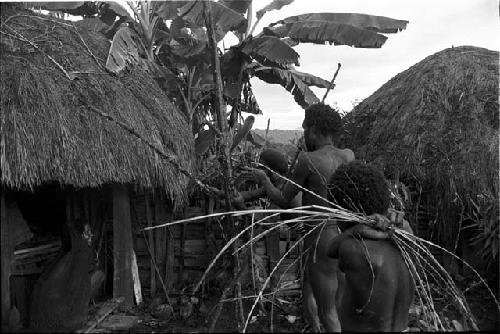 Uwar watches in foreground as Yoli and Yegé Asuk prepare the ceremony to cure Loliluk's wife