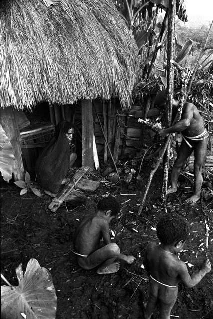 Yegé Asuk creating a structure to help cure Lolikuk's ill wife