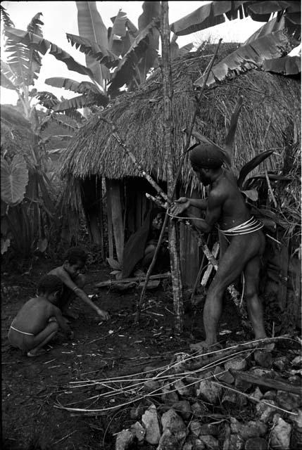 Yegé Asuk creating a structure to help cure Loliluk's ill wife