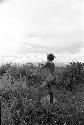 Woman washing hiperi in the fields, she has clay on her