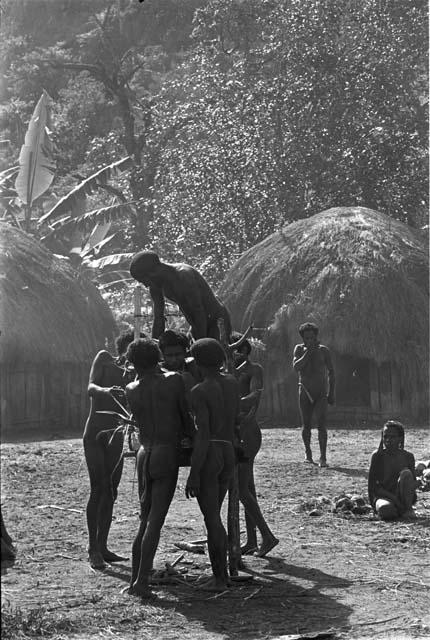 Preparing the pia with Yonokma in it; tying him into the pia during the early part of the ceremony