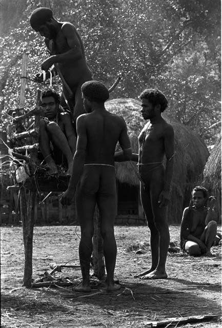 Preparing the pia with Yonokma in it; tying him into the pia during the early part of the ceremony