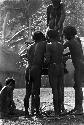 Men arranging Yonokma's corpse on the pia in the early parts of the funeral ceremony