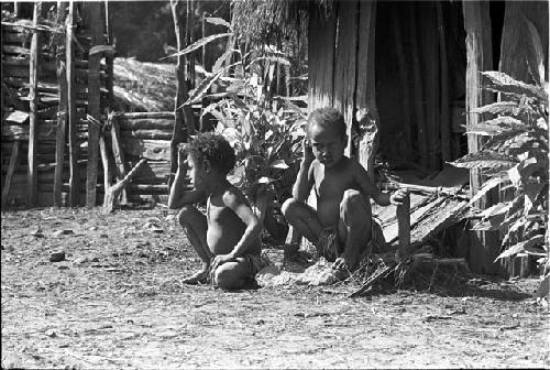 Two little children watch the ceremony of Yonokma's funeral