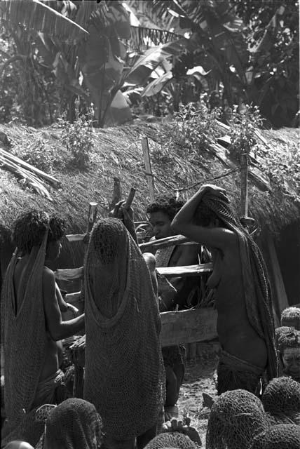 Three women grouped around Yonokma's corpse at his funeral