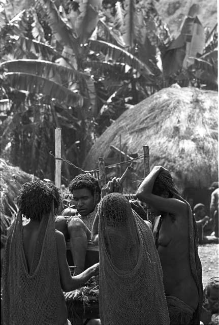 Three women grouped around Yonokma's corpse at his funeral