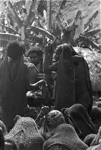 Three women grouped around Yonokma's corpse at his funeral