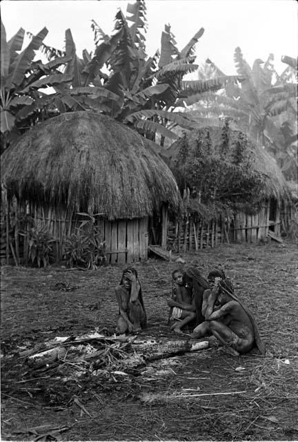 Early morning after Yonokma's funeral, four women sit by the dead fire that burned Yonokma