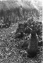 Large group of women sit outside the hunu