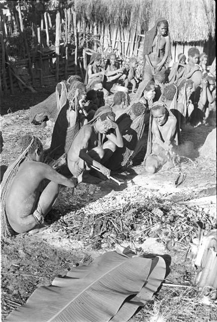 Women picking bones out of the dead fire on which Yonokma was cremated