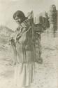 Navajo woman carrying a baby