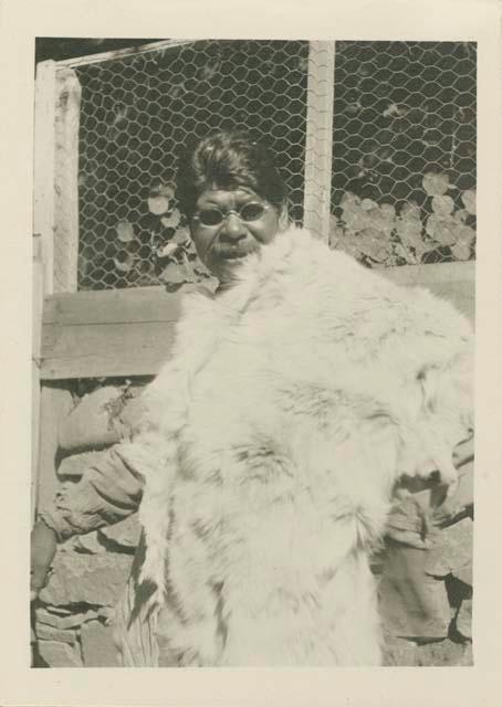 Canyon Billy, blind, wearing dark glasses and white deer skin robe