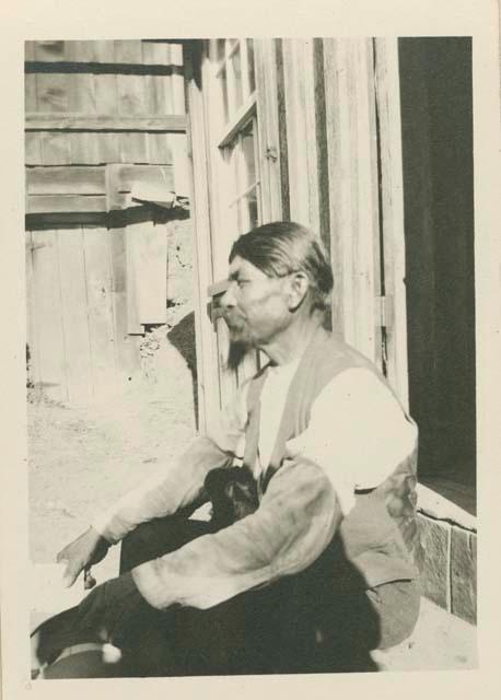 Billy Smithson sitting on the stoop of a house