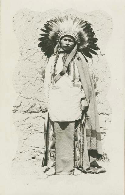 Man wearing blanket and feather headdress