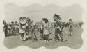 Jicarilla Apache men in ceremonial dress performing a dance at agency in southwest Colorado
